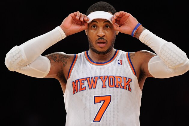 NEW YORK, NY - DECEMBER 16:  Carmelo Anthony #7 of the New York Knicks looks on during the second half against the Washington Wizards at Madison Square Garden on December 16, 2013 in New York City. NOTE TO USER: User expressly acknowledges and agrees that, by downloading and/or using this photograph, user is consenting to the terms and conditions of the Getty Images License Agreement. The Wizards defeat the Knicks 102-101.  (Photo by Maddie Meyer/Getty Images)
