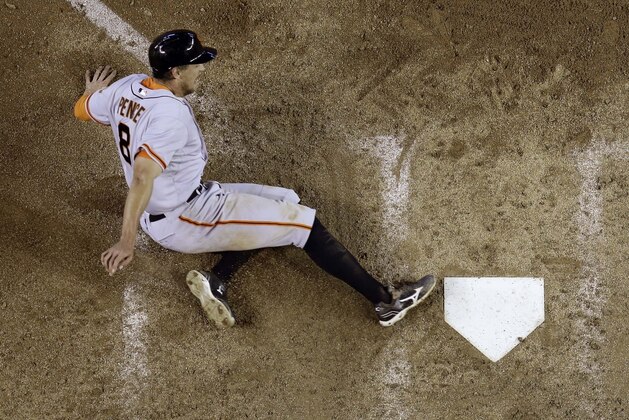 San Francisco Giants' Hunter Pence scores on an RBI double by teammate Buster Posey against the Arizona Diamondbacks during the ninth inning of a baseball game, Sunday, June 22, 2014, in Phoenix. (AP Photo/Matt York)