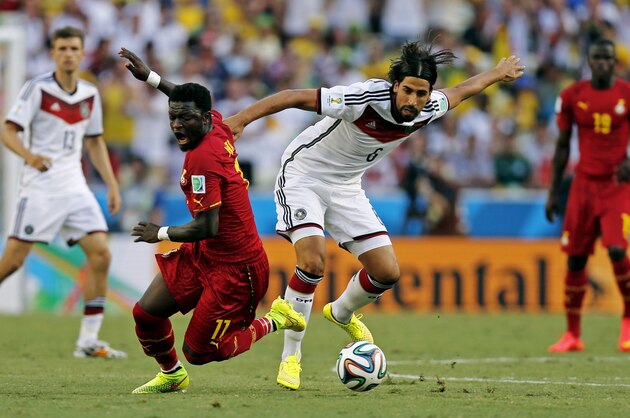 Ghana's Sulley Muntari, left, is challenged by Germany's Sami Khedira during the group G World Cup soccer match between Germany and Ghana at the Arena Castelao in Fortaleza, Brazil, Saturday, June 21, 2014. (AP Photo/Frank Augstein)