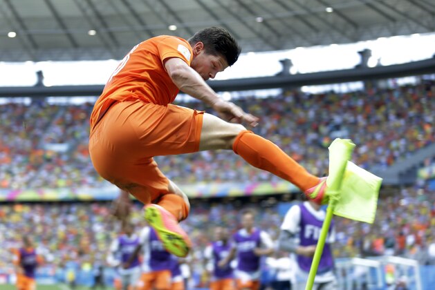Netherlands' Klaas-Jan Huntelaar celebrates after scoring his side's second goal during the World Cup round of 16 soccer match between the Netherlands and Mexico at the Arena Castelao in Fortaleza, Brazil, Sunday, June 29, 2014.  The Netherlands won the match 2-1. (AP Photo/Natacha Pisarenko)