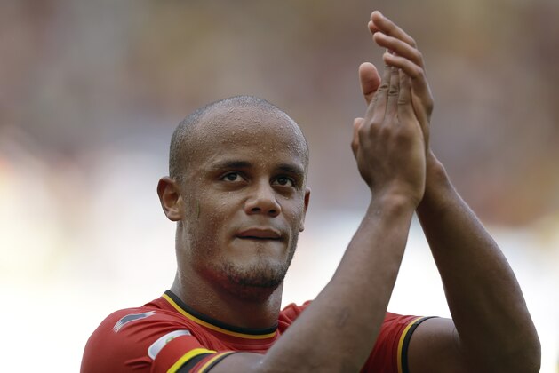 Belgium's Vincent Kompany applauds following Belgium's 1-0 victory over Russia during the group H World Cup soccer match between Belgium and Russia at the Maracana Stadium in Rio de Janeiro, Brazil, Sunday, June 22, 2014. (AP Photo/Natacha Pisarenko)