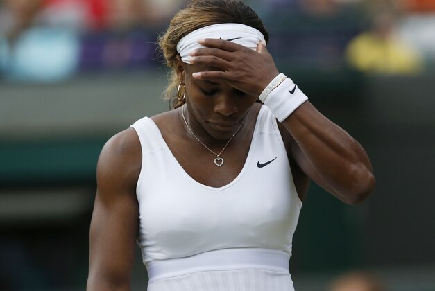 Serena Williams of U.S. gestures after losing a point to Alize Cornet of France during their women's singles match at the All England Lawn Tennis Championships in Wimbledon, London, Saturday, June 28, 2014. (AP Photo/Sang Tan)