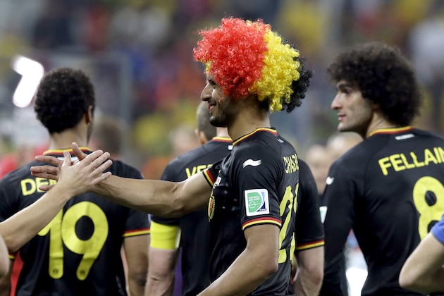 Belgium's Nacer Chadli, left, is congratulated by a teammate following Belgium's 1-0 victory over South Korea to Belgium during the group H World Cup soccer match between South Korea and Belgium at the Itaquerao Stadium in Sao Paulo, Brazil, Thursday, June 26, 2014. (AP Photo/Thanassis Stavrakis)
