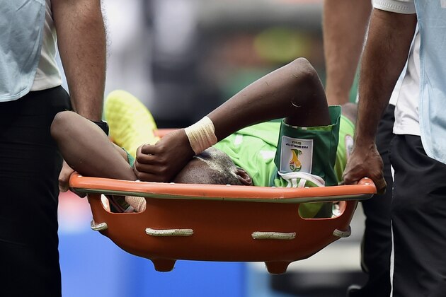 Nigeria's Ogenyi Onazi is carried from the pitch after getting  injured during the World Cup round of 16 soccer match between France and Nigeria at the Estadio Nacional in Brasilia, Brazil, Monday, June 30, 2014. (AP Photo/Martin Meissner)