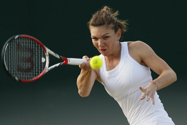 Simona Halep of Romania plays a return to Belinda Bencic of Switzerland during their women's singles match at the All England Lawn Tennis Championships in Wimbledon, London, Saturday, June 28, 2014. (AP Photo/Alastair Grant)