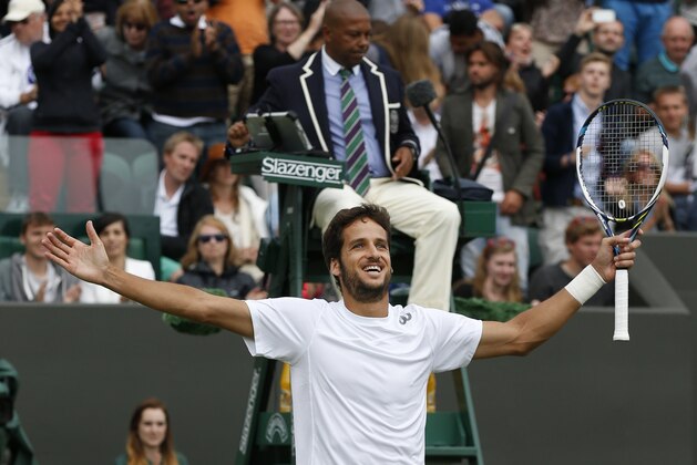 Feliciano Lopez of Spain celebrates after defeating John Isner of the U.S. during their men's singles match at the All England Lawn Tennis Championships in Wimbledon, London, Monday, June 30, 2014. (AP Photo/Sang Tan)