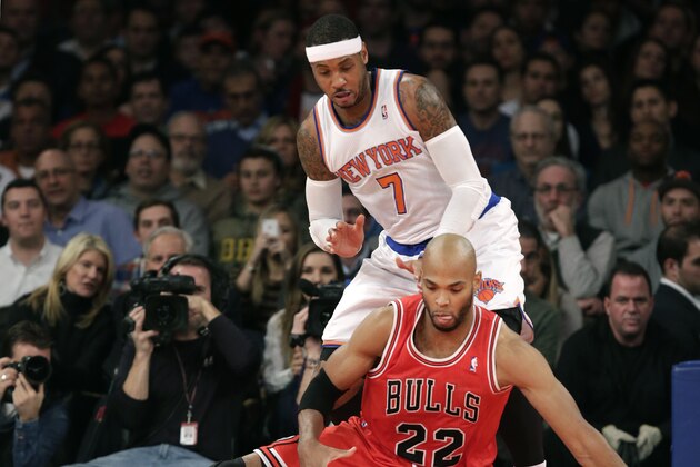 Chicago Bulls forward Taj Gibson (22) slips and loses the ball beneath New York Knicks forward Carmelo Anthony (7) in the first half of their NBA basketball game at Madison Square Garden in New York, Wednesday, Dec. 11, 2013.  (AP Photo/Kathy Willens)