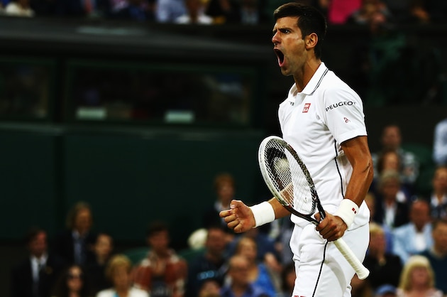 LONDON, ENGLAND - JUNE 30:  Novak Djokovic of Serbia celebrates a point during his Gentlemen's Singles fourth round match against Jo-Wilfried Tsonga of France on day seven of the Wimbledon Lawn Tennis Championships at the All England Lawn Tennis and Croquet Club on June 30, 2014 in London, England.  (Photo by Clive Brunskill/Getty Images)