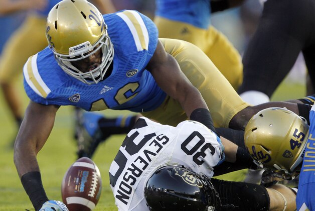 UCLA linebacker Kenny Orjioke, left, and UCLA linebacker Cameron Judge, right, cause Colorado returner Ryan Severson (30) to fumble on a kickoff return, which is recovered by UCLA in the first half of their NCAA college football game Saturday, Nov. 2, 2013, in Pasadena, Calif. (AP Photo/Alex Gallardo)