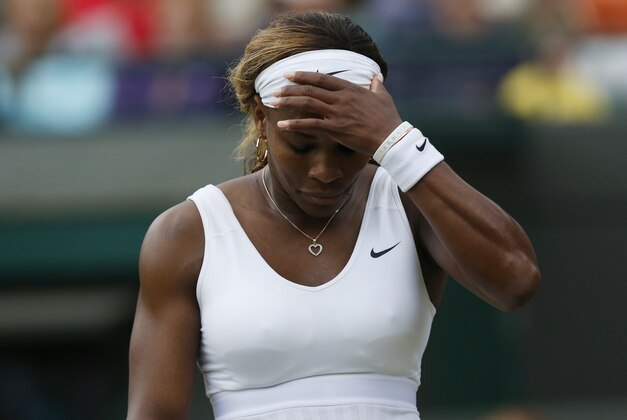 Serena Williams of U.S. gestures after losing a point to Alize Cornet of France during their women's singles match at the All England Lawn Tennis Championships in Wimbledon, London, Saturday, June 28, 2014. (AP Photo/Sang Tan)
