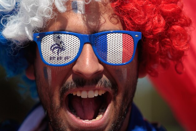 A France soccer fan, with his face painted with the team's colors arrives at the National Stadium to watch World Cup round of 16 match against Nigeria, in Brasilia, Brazil, Monday, June 30, 2014. France's Paul Pogba scored with a late header to finally break Nigeria’s stubborn resistance and Joseph Yobo scored an own-goal as France won 2-0 to reach the World Cup quarterfinals on Monday. (AP Photo/Eraldo Peres)