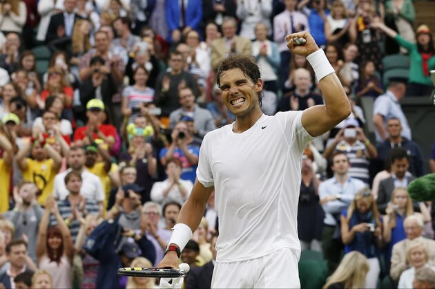 Rafael Nadal of Spain celebrates defeating Mikhail Kukushkin of Kazakhstan in their men's singles match at the All England Lawn Tennis Championships in Wimbledon, London, Saturday, June 28, 2014. (AP Photo/Ben Curtis)