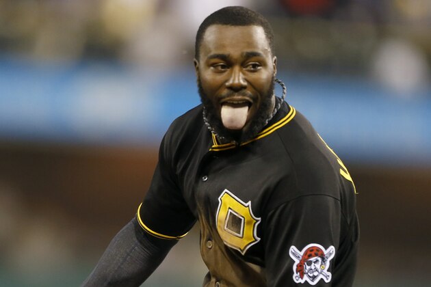 Pittsburgh Pirates' Josh Harrison (5) runs away from his teammates after he drove in Clint Barmes with the game-winning run in the 11th inning of the baseball game against the New York Mets on Friday, June 27, 2014, in Pittsburgh. The Pirates won 3-2 in 11 innings. (AP Photo/Keith Srakocic)