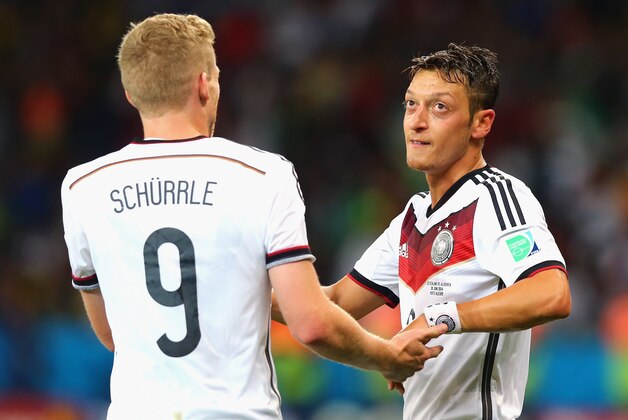 PORTO ALEGRE, BRAZIL - JUNE 30:  Mesut Oezil of Germany (R) celebrates scoring his team's second goal in extra time with Andre Schuerrle during the 2014 FIFA World Cup Brazil Round of 16 match between Germany and Algeria at Estadio Beira-Rio on June 30, 2014 in Porto Alegre, Brazil.  (Photo by Martin Rose/Getty Images)