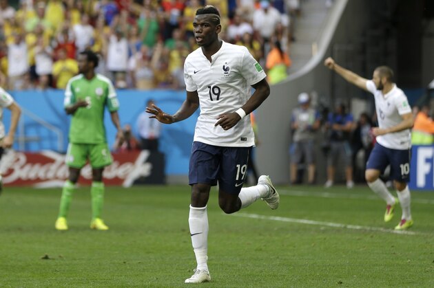 France's Paul Pogba celebrates after scoring during the World Cup round of 16 soccer match between France and Nigeria at the Estadio Nacional in Brasilia, Brazil, Monday, June 30, 2014.Pogba scored with a late header to finally break Nigeria's stubborn resistance and Joseph Yobo scored an own-goal as France won 2-0 to reach the World Cup quarterfinals on Monday. (AP Photo/Ricardo Mazalan)