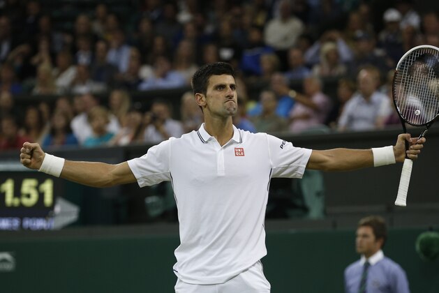 Novak Djokovic of Serbia celebrates defeating Jo-Wilfried Tsonga of France in their men's singles match at the All England Lawn Tennis Championships in Wimbledon, London, Monday, June 30, 2014. (AP Photo/Pavel Golovkin)