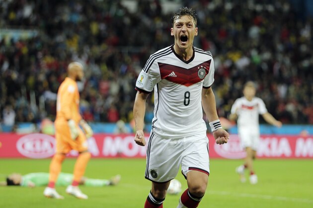 Germany's Mesut Ozil celebrates after scoring his side's second goal in extra time during the World Cup round of 16 soccer match between Germany and Algeria at the Estadio Beira-Rio in Porto Alegre, Brazil, Monday, June 30, 2014. Germany defeated Algeria 2-1 to advance to the quarterfinals.  (AP Photo/Matthias Schrader)