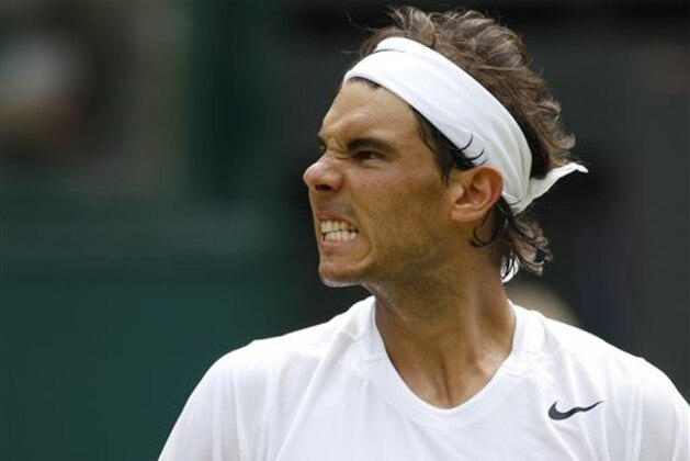 Rafael Nadal of Spain celebrates a point during the men's singles match against Lukas Rosol of the Czech Republic at the All England Lawn Tennis Championships in Wimbledon, London, Thursday, June 26, 2014. (AP Photo/Pavel Golovkin)