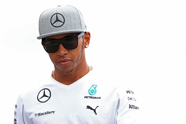 MONTREAL, QC - JUNE 05:  Lewis Hamilton of Great Britain and Mercedes GP walks across the paddock ahead of the Canadian Formula One Grand Prix at Circuit Gilles Villeneuve on June 5, 2014 in Montreal, Canada.  (Photo by Mark Thompson/Getty Images)