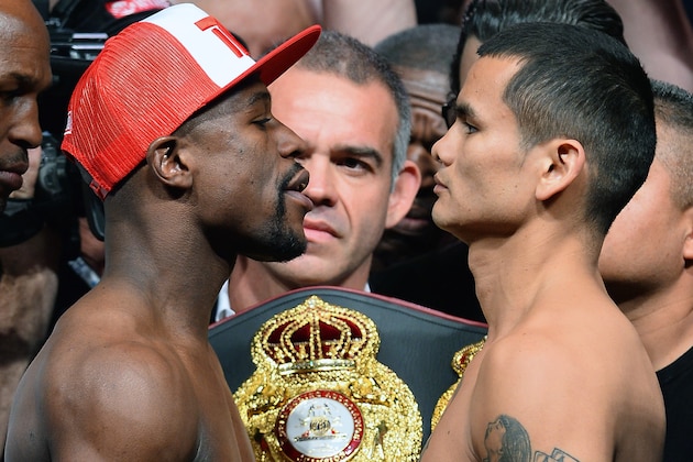LAS VEGAS, NV - MAY 02:  WBC welterweight champion Floyd Mayweather Jr. (L) and WBA champion Marcos Maidana face off during their official weigh-in at the MGM Grand Garden Arena on May 2, 2014 in Las Vegas, Nevada. The two will meet in a WBC/WBA unification fight in Las Vegas on May 3.  (Photo by Ethan Miller/Getty Images)
