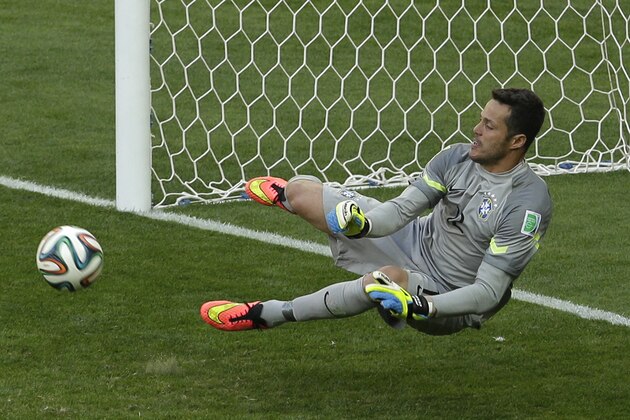 Brazil's goalkeeper Julio Cesar make a save in the shoot-out of the World Cup round of 16 soccer match between Brazil and Chile at the Mineirao Stadium in Belo Horizonte, Brazil, Saturday, June 28, 2014.  Brazil won 3-2 on penalties after the match ended 1-1 draw after extra-time.  (AP Photo/Hassan Ammar)