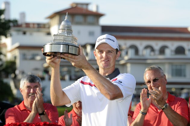 Justin Rose, of England, poses with the trophy after he won the Quicken Loans National golf tournament, Sunday, June 29, 2014, in Bethesda, Md. Rose won in a one-hole playoff. (AP Photo/Nick Wass)