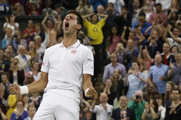 Novak Djokovic of Serbia celebrates defeating Jo-Wilfried Tsonga of France in their men's singles match at the All England Lawn Tennis Championships in Wimbledon, London, Monday, June 30, 2014. (AP Photo/Pavel Golovkin)
