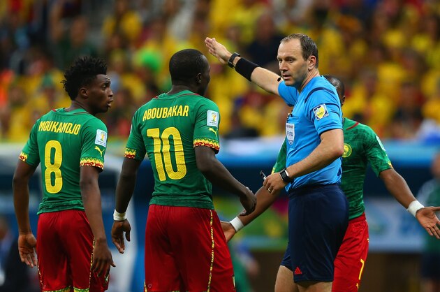 BRASILIA, BRAZIL - JUNE 23: Referee Jonas Eriksson speaks to Benjamin Moukandjo (L) and Vincent Aboubakar of Cameroon during the 2014 FIFA World Cup Brazil Group A match between Cameroon and Brazil at Estadio Nacional on June 23, 2014 in Brasilia, Brazil.  (Photo by Clive Brunskill/Getty Images)