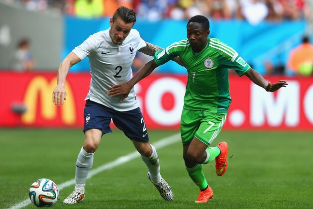 BRASILIA, BRAZIL - JUNE 30:  Mathieu Debuchy of France is challenged by Ahmed Musa of Nigeria during the 2014 FIFA World Cup Brazil Round of 16 match between France and Nigeria at Estadio Nacional on June 30, 2014 in Brasilia, Brazil.  (Photo by Jeff Gross/Getty Images)