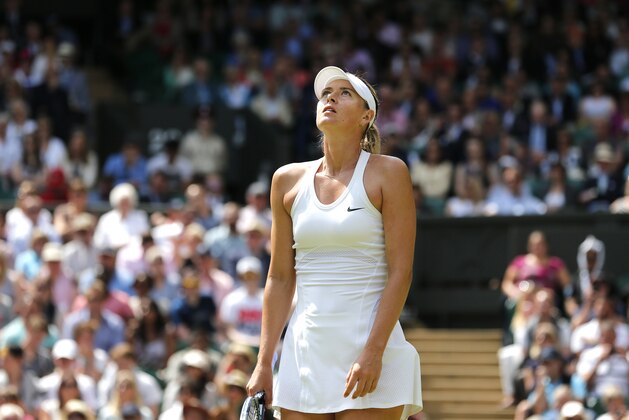 Maria Sharapova of Russia looks up after losing a point to Angelique Kerber of Germany during their women's singles  match at the All England Lawn Tennis Championships in Wimbledon, London, Tuesday, July 1, 2014. (AP Photo/Ben Curtis)