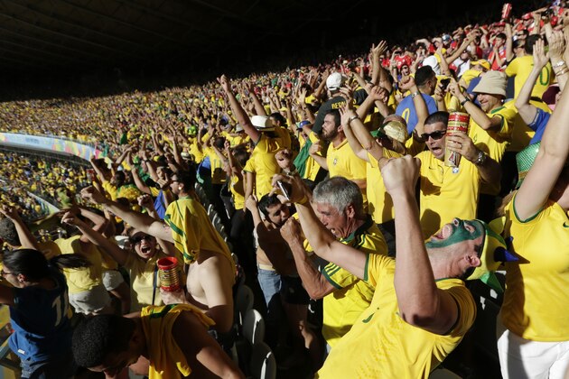 Brazil soccer fans celebrate defeating Chile in a penalty shootout at the World Cup round of 16 soccer match at Mineirao Stadium in Belo Horizonte, Brazil, Saturday, June 28, 2014. (AP Photo/Petr David Josek)