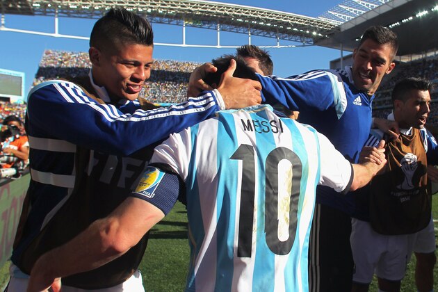 SAO PAULO, BRAZIL - JULY 01:  Lionel Messi of Argentina celebrates with teammates defeating Switzerland 1-0 in extra time during the 2014 FIFA World Cup Brazil Round of 16 match between Argentina and Switzerland at Arena de Sao Paulo on July 1, 2014 in Sao Paulo, Brazil.  (Photo by Julian Finney/Getty Images)