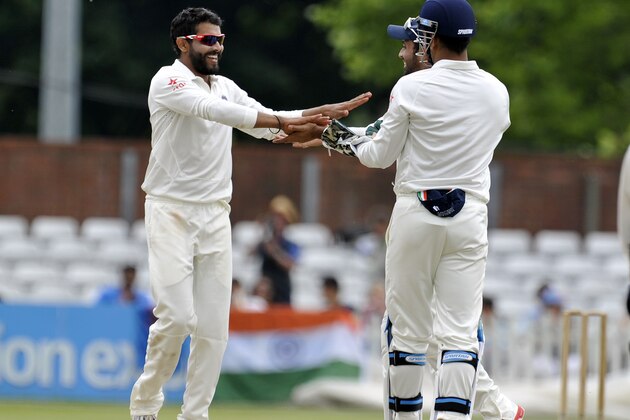 DERBY, ENGLAND - JULY 1:  Ravindra Jadeja (L) of India celebrates after he takes the wicket of Derbyshire's Ben Slater during day one of the tour match between Derbyshire and India at The 3aaa County Ground on July 1, 2014 in Derby, England. (Photo by Clint Hughes/Getty Images)