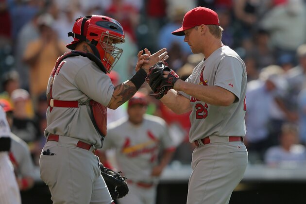 DENVER, CO - JUNE 25:  Catcher Yadier Molina #4 and pitcher Trevor Rosenthal #26 of the St. Louis Cardinals celebrate as Rosenthal earned a save in their 9-6 victory over the Colorado Rockies at Coors Field on June 25, 2014 in Denver, Colorado.  (Photo by Doug Pensinger/Getty Images)