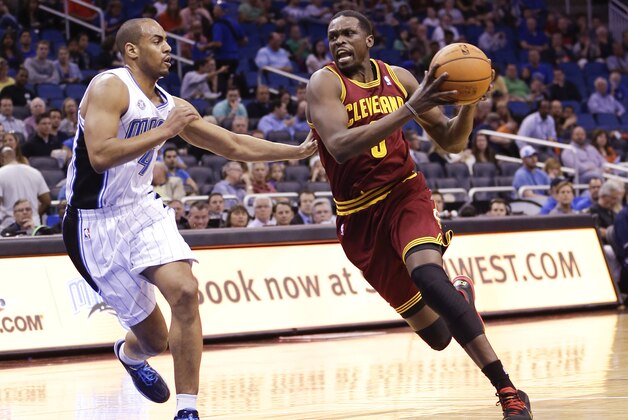 Cleveland Cavaliers' Luol Deng, right, drives around Orlando Magic's Arron Afflalo, left, during the first half of an NBA basketball game in Orlando, Fla., Wednesday, April 2, 2014. (AP Photo/John Raoux)