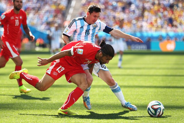 SAO PAULO, BRAZIL - JULY 01:  Ricardo Rodriguez of Switzerland challenges Lionel Messi of Argentina during the 2014 FIFA World Cup Brazil Round of 16 match between Argentina and Switzerland at Arena de Sao Paulo on July 1, 2014 in Sao Paulo, Brazil.  (Photo by Jamie Squire/Getty Images)