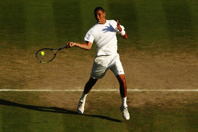 LONDON, ENGLAND - JULY 01:  Nick Kyrgios of Australia returns during his Gentlemen's Singles fourth round match against Rafael Nadal of Spain on day eight of the Wimbledon Lawn Tennis Championships at the All England Lawn Tennis and Croquet Club on July 1, 2014 in London, England.  (Photo by Matthew Stockman/Getty Images)