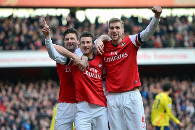 LONDON, ENGLAND - FEBRUARY 22:  Laurent Koscielny of Arsenal (C) celebrates with team-mates Olivier Giroud of Arsenal (L) and Per Mertesacker of Arsenal after scoring their third goal during the Barclays Premier League match between Arsenal and Sunderland at Emirates Stadium on February 22, 2014 in London, England.  (Photo by Michael Regan/Getty Images)