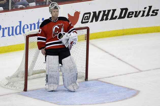 New Jersey Devils goalie Martin Brodeur stands in goal late in the third period of an NHL hockey game against the Boston Bruins in Newark, N.J., Sunday, April 13, 2014. The Devils won 3-2. (AP Photo/Mel Evans)