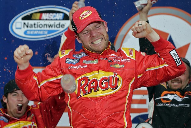 Regan Smith celebrates in Victory Lane after winning the NASCAR Nationwide series auto race at Daytona International Speedway in Daytona Beach, Fla., Saturday, Feb. 22, 2014. (AP Photo/Chuck Burton)