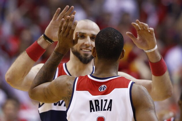 Washington Wizards forward Trevor Ariza (1) receives a high five from Washington Wizards center Marcin Gortat from Poland (4) during the second half of Game 4 of an opening-round NBA basketball playoff series in Washington, Sunday, April 27, 2014. The Washington Wizards defeated the Chicago Bulls 98-89 to lead the series 3-1. (AP Photo/Alex Brandon)