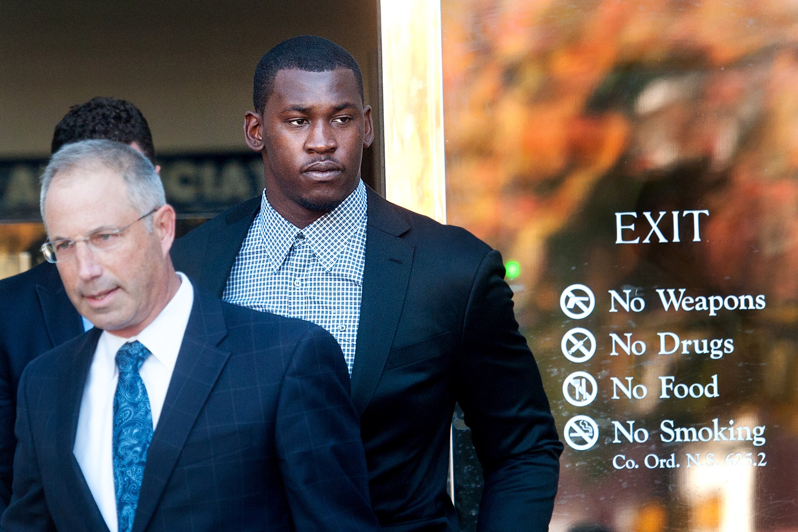 Accompanied by his attorney Joshua Bentley, left, San Francisco 49ers linebacker Aldon Smith leaves an arraignment at Santa Clara County Superior Court on Tuesday, Nov, 12, 2013, in San Jose, Calif. Smith faces three felony counts of illegal possession of an automatic weapon stemming from a party at his home in June 2012. (AP Photo/Noah Berger)