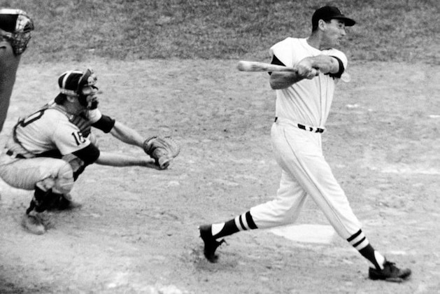 Slugger Ted Williams follows through with his old-time power as he slams the 505th home run of his major league career in fourth inning against Detroit Tigers at Fenway Park June 30, 1960. Home run was 13th of the season for Williams who missed many early games this year. Since he returned to regular lineup June 5. (AP Photo)