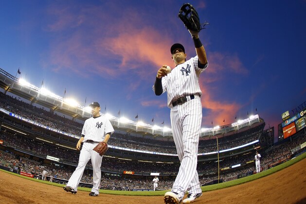 NEW YORK, NY - JUNE 28: Masahiro Tanaka #19 and Brian Roberts #14 of the New York Yankees walk off the field after the fifth inning against the Boston Red Sox in a MLB baseball game at Yankee Stadium on June 28, 2014 in the Bronx borough of New York City. (Photo by Rich Schultz/Getty Images)