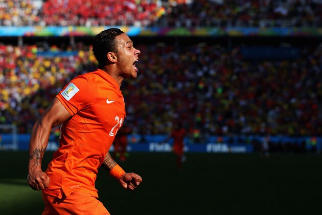 SAO PAULO, BRAZIL - JUNE 23:  Memphis Depay of the Netherlands celebrates scoring his team's second goal during the 2014 FIFA World Cup Brazil Group B match between the Netherlands and Chile at Arena de Sao Paulo on June 23, 2014 in Sao Paulo, Brazil. (Photo by Dean Mouhtaropoulos/Getty Images)