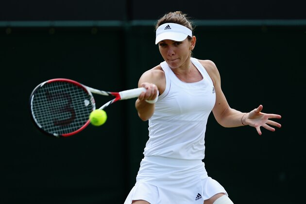 LONDON, ENGLAND - JULY 01:  Simona Halep of Romania plays a forehand return during her Ladies' Singles fourth round match against Zarina Diyas of Kazakhstan on day eight of the Wimbledon Lawn Tennis Championships at the All England Lawn Tennis and Croquet Club on July 1, 2014 in London, England.  (Photo by Matthew Stockman/Getty Images)