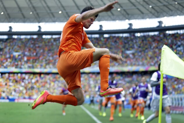 Netherlands' Klaas-Jan Huntelaar celebrates after scoring his side's second goal during the World Cup round of 16 soccer match between the Netherlands and Mexico at the Arena Castelao in Fortaleza, Brazil, Sunday, June 29, 2014.  The Netherlands won the match 2-1. (AP Photo/Natacha Pisarenko)