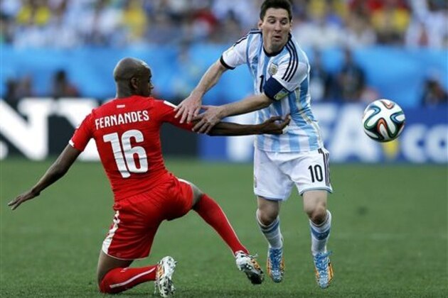 CORRECTS NAME OF MARCOS ROJO TO GELSON FERNANDES - Switzerland's Gelson Fernandes, left, tries to stop Argentina's Lionel Messi during the World Cup round of 16 soccer match between Argentina and Switzerland at the Itaquerao Stadium in Sao Paulo, Brazil, Tuesday, July 1, 2014. (AP Photo/Victor R. Caivano)