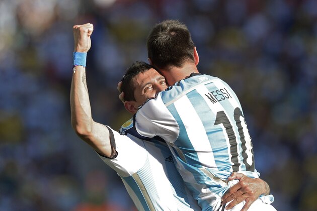 Argentina's Lionel Messi celebrates with Angel di Maria after di Maria scored his side's only and winning goal in extra time during the World Cup round of 16 soccer match between Argentina and Switzerland at the Itaquerao Stadium in Sao Paulo, Brazil, Tuesday, July 1, 2014. Argentina defeated Switzerland 1-0 to move on to the quarterfinals. (AP Photo/Manu Fernandez)