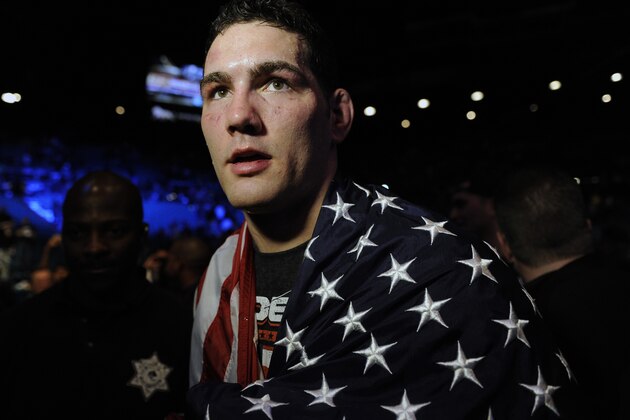 Chris Weidman, of Baldwin, N.Y., walks after defeating Anderson Silva, of Brazil, during the UFC 168 mixed martial arts middleweight championship bout on Saturday, Dec. 28, 2013, in Las Vegas. Weidman won during the second round by a technical knockout after Silva was injured. (AP Photo/David Becker)